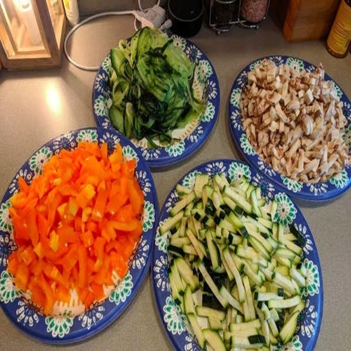 Various plates of chopped veggies