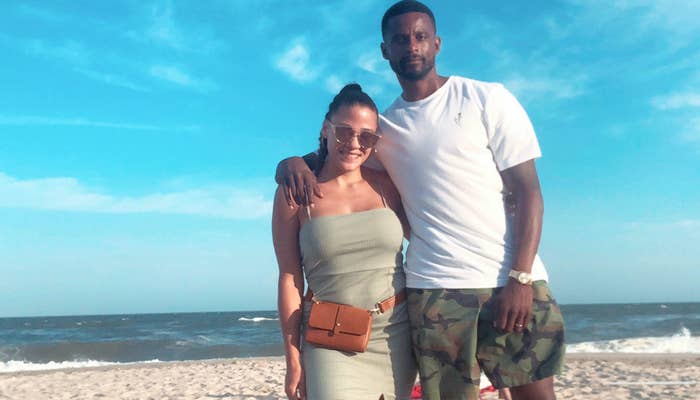 Dean Gaskin stands with his arm around his wife, Jasmin, while on a sunny beach.