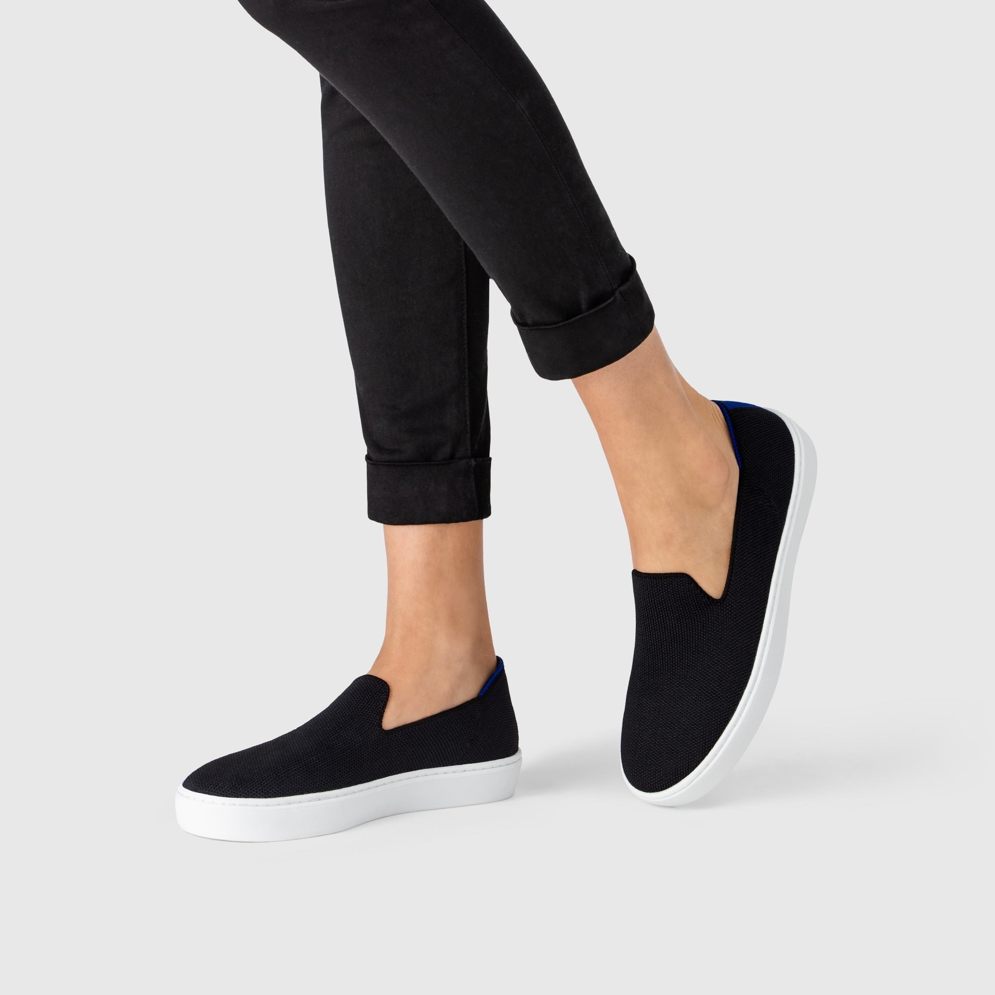 The black slip-on shoes with thick white soles