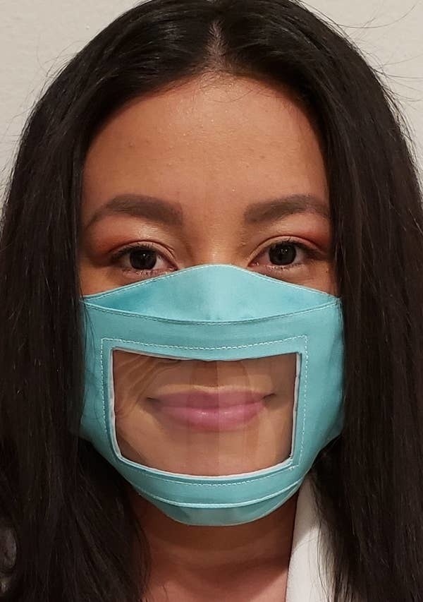 A person wearing the clear panel non-medical face mask in light blue