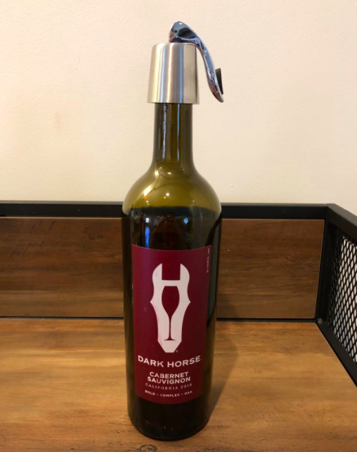 Reviewer photo showing the wine stopper in use on a bottle of red wine