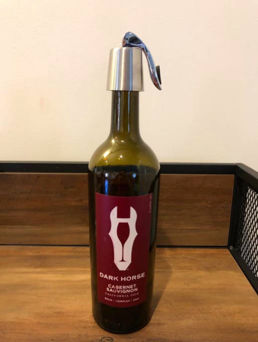 Reviewer photo showing the wine stopper in use on a bottle of red wine