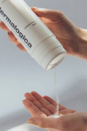 model pouring product from white bottle into hand 