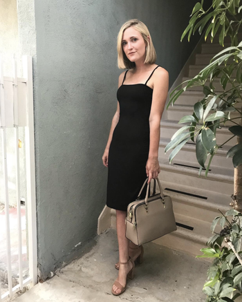 Different reviewer wearing the black version with heels