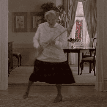 GIF of Mrs. Doubtfire dancing and holding a broom as a guitar. Peak Mrs. Doubtfire. Peak Robin Williams here.