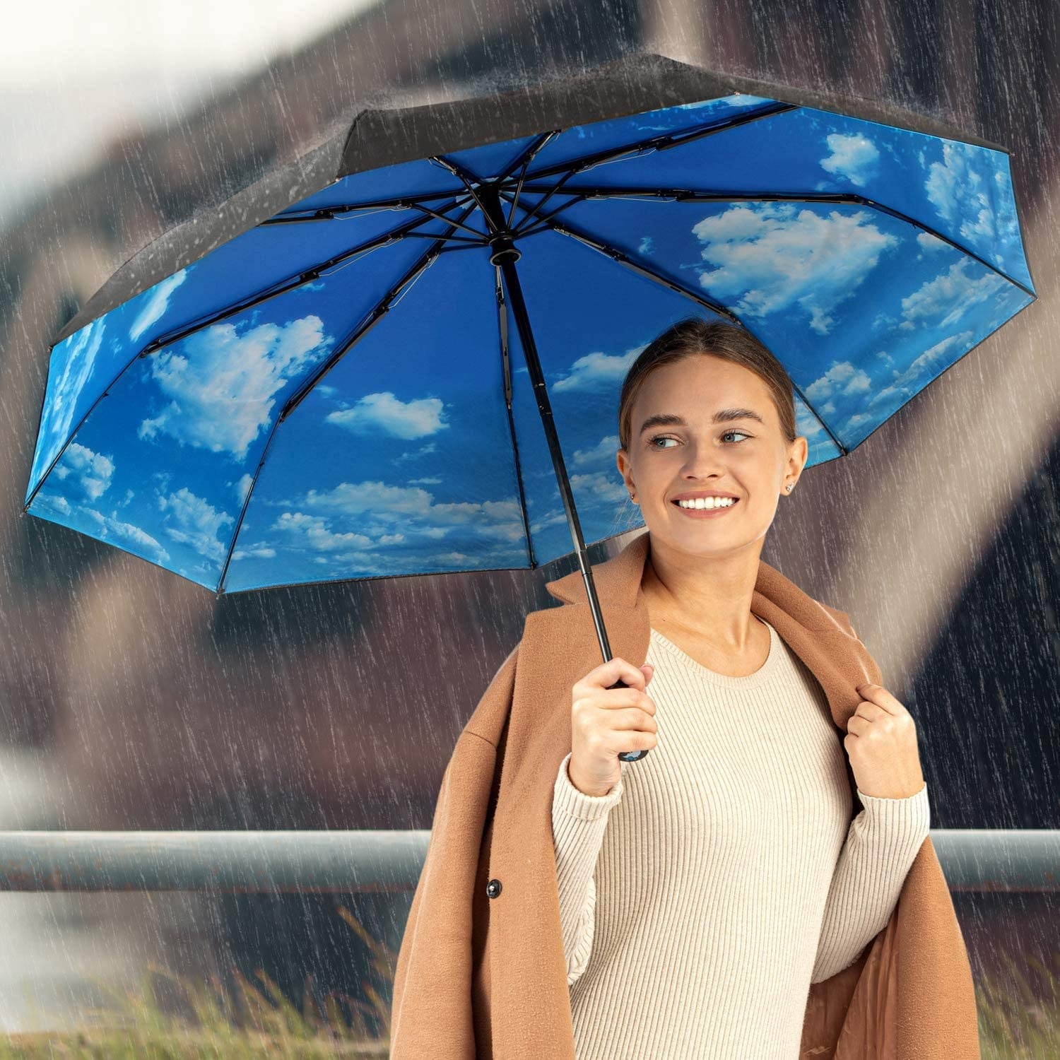 Model holding a black umbrella with a cloudy blue sky pattern on the inside