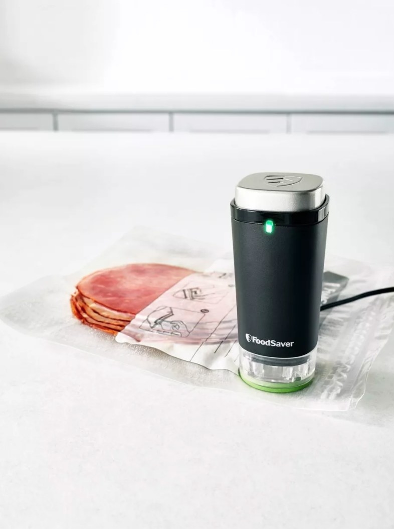 A black FoodSaver device with green power light activated