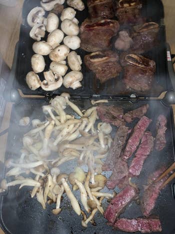 a reviewer photo showing the griddler fully open and cooking veggies, meat, and potatoes on it all at once
