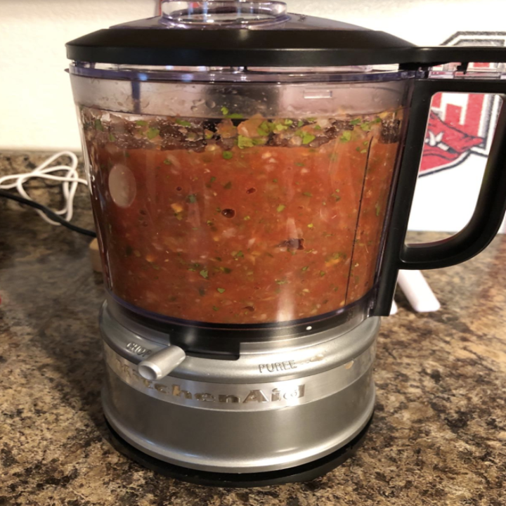 salsa being pureed in a kitchenaid food chopper