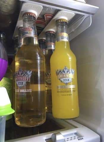 a reviewer's photo of six glass bottles hanging inside their fridge
