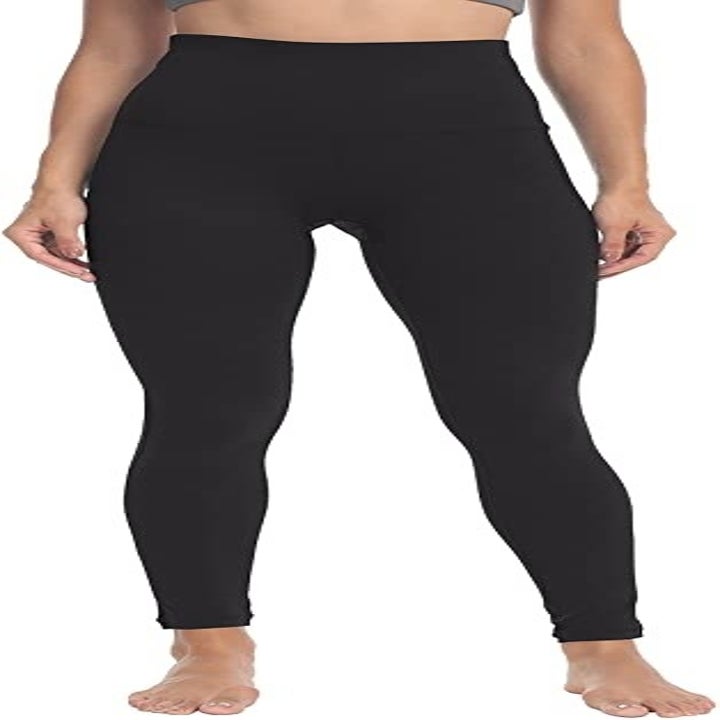 A person showing the front of the high-waisted leggings