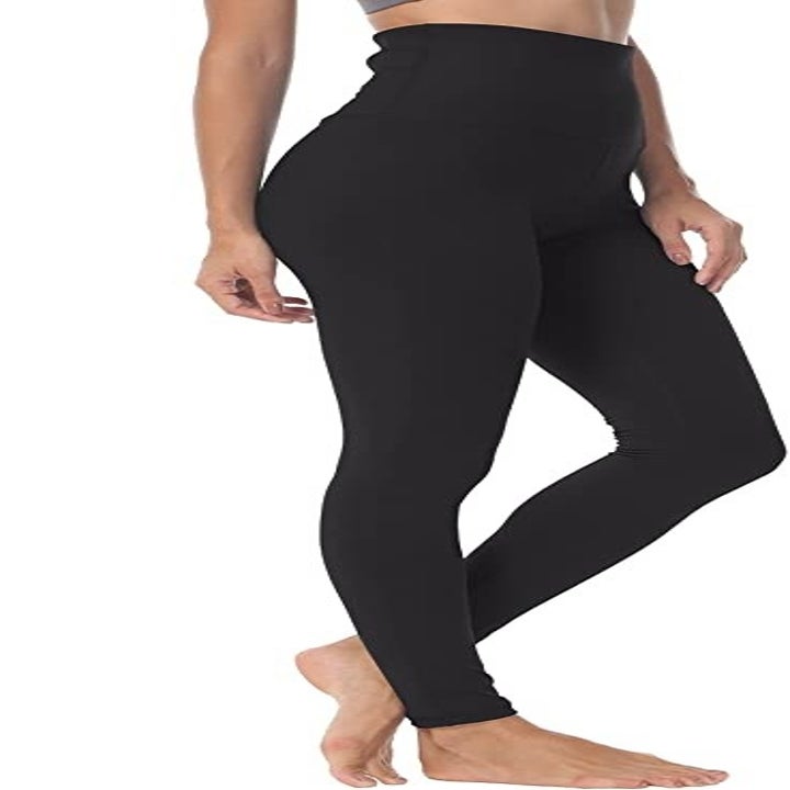A person showing the side of the high-waisted leggings