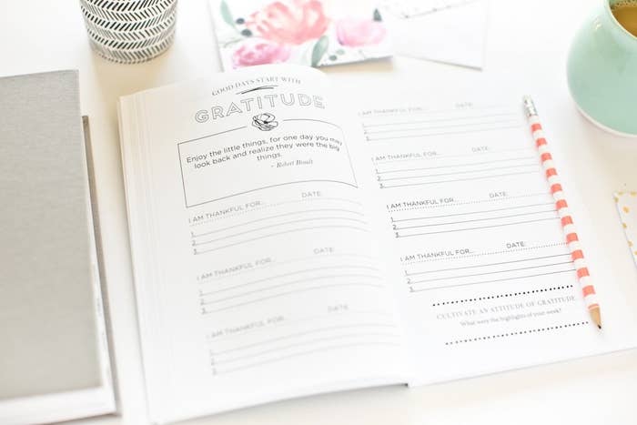 An open gratitude activity journal on a desk