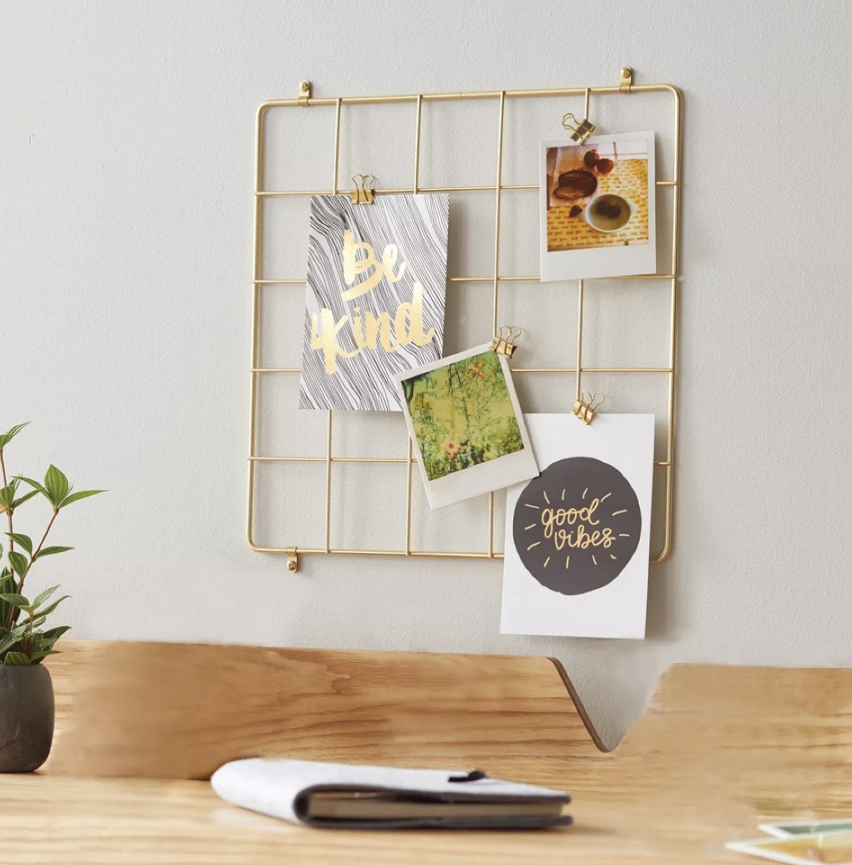 Organizer located on a desk wall featuring greeting cards and photos displayed