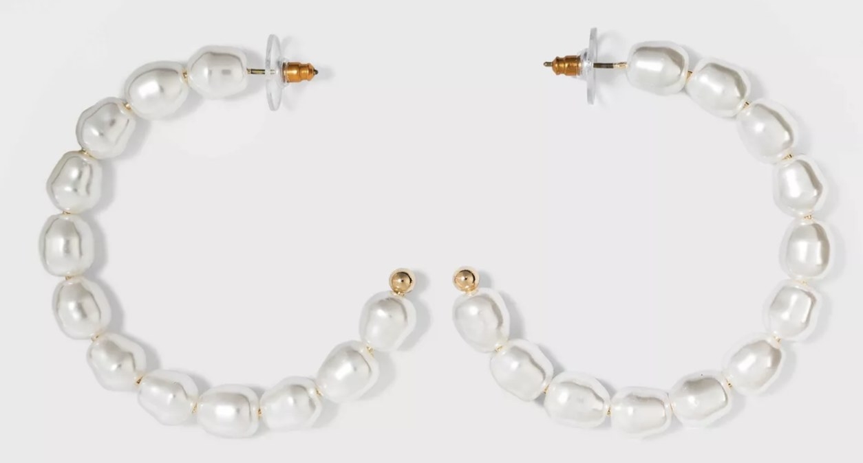The earrings, featuring irregular-shaped pearls