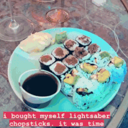 BuzzFeed editor using the glowing, blue chopsticks to eat sushi