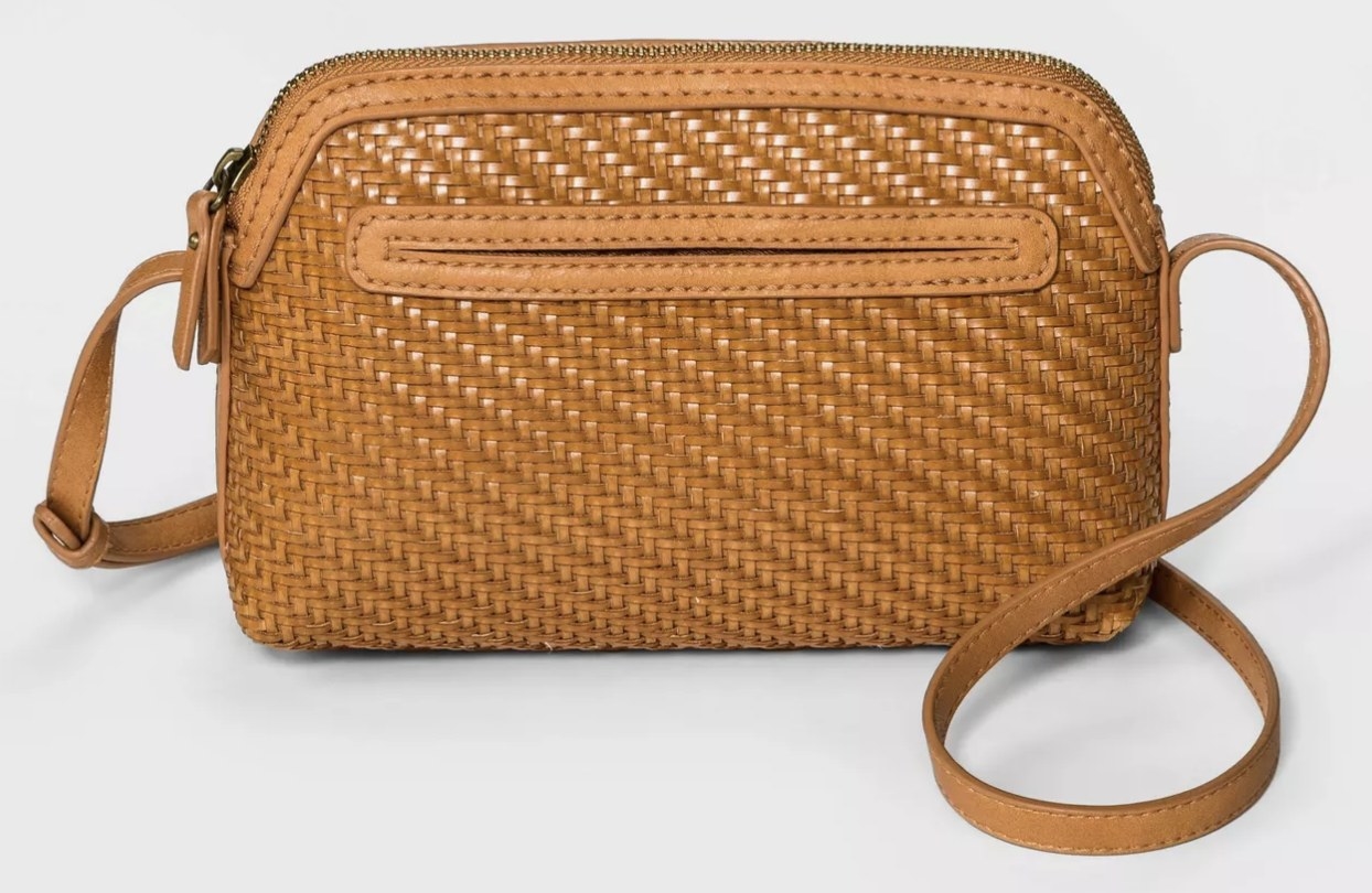 The bag in the color cognac, featuring a woven design
