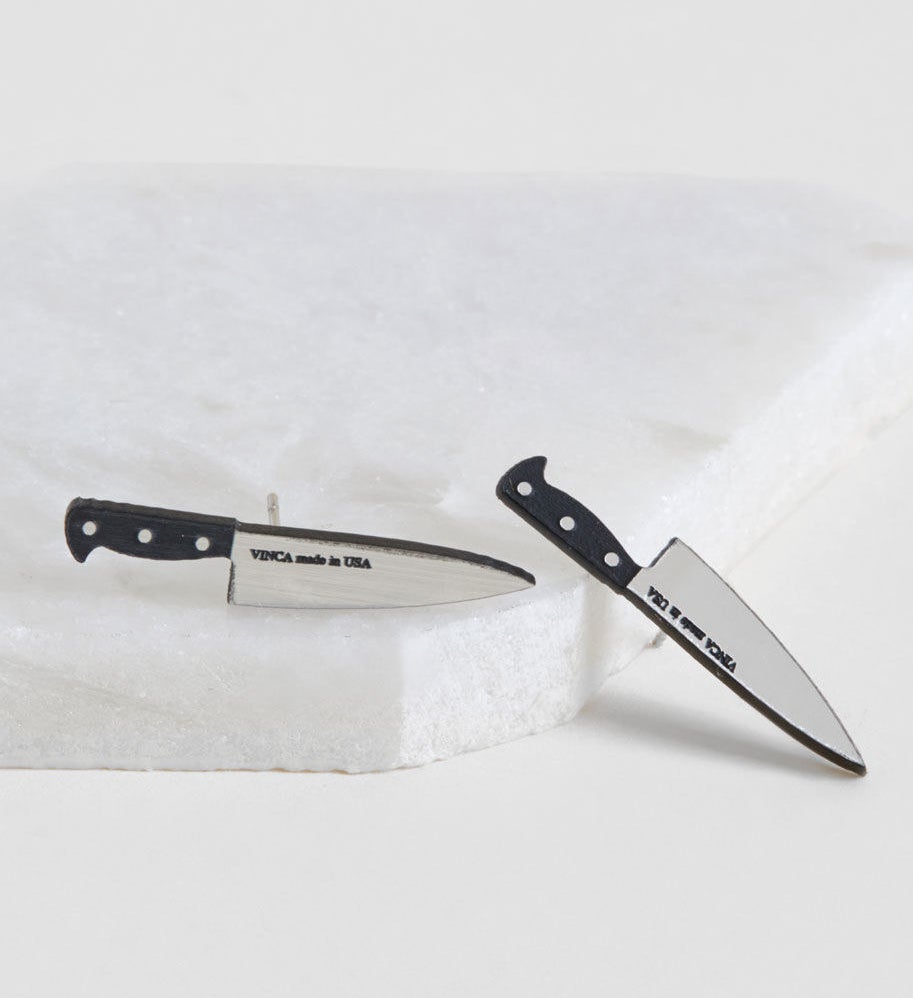 Stud earrings that look like small kitchen knives with black handles