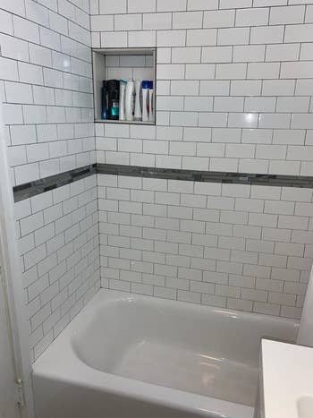 Same reviewer's after picture of perfectly white shower tiles 