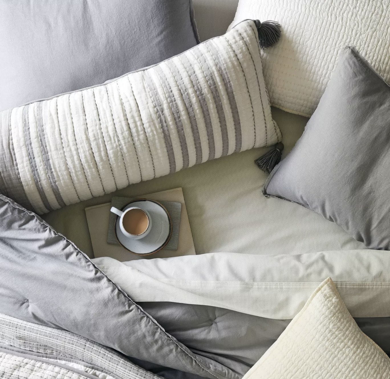 The rectangular gray and white striped throw pillow 