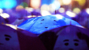 Gif of the blue umbrella happily enjoying the rain 