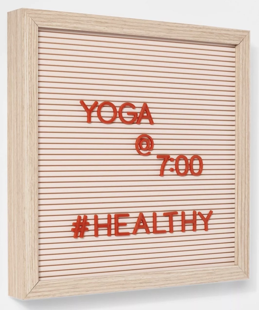 The pink letterboard displays &quot;Yoga @ 7:00 #Healthy&quot; 