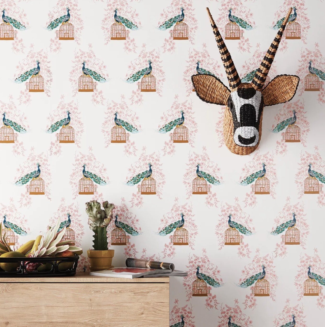 The wallpaper with illustrations of peacocks resting on gold cages 