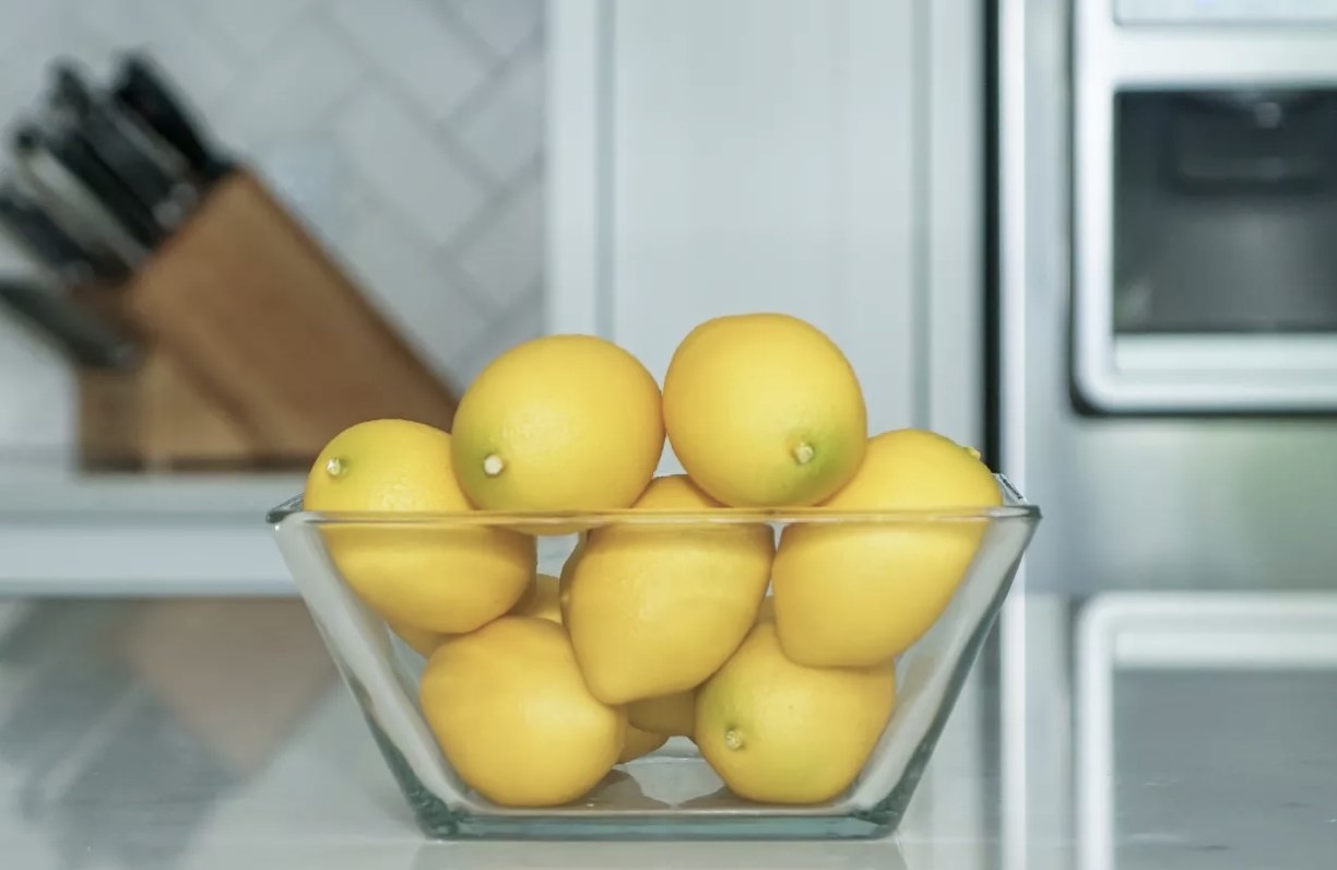 A bowl of faux lemons on a kitchen countertop