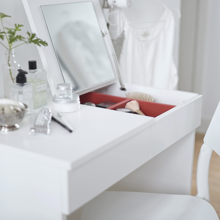 Closeup of the vanity with the right side open, showing that it has a mirror and spaces with makeup and accessories in it