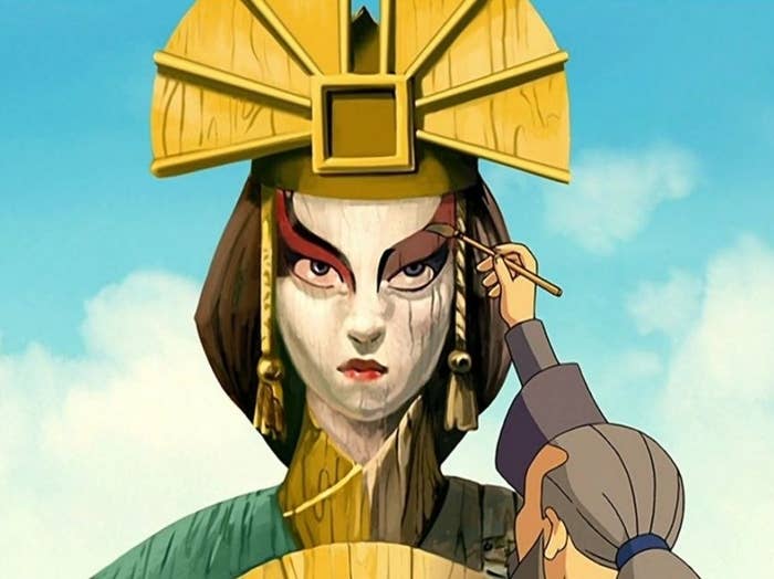 A village person repainting Kyoshi&#x27;s statue with a paintbrush