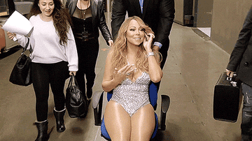 Body guard pushing Mariah Carey to the concert stage