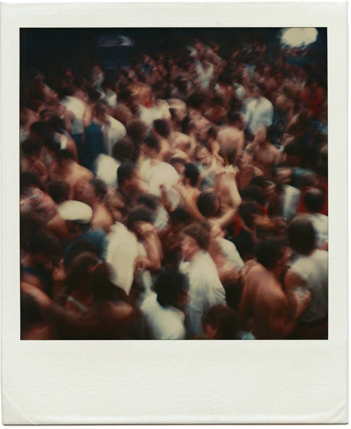 A polaroid provided by the artist Tom Bianchi of a Fire Island party packed with people from his collection of work documenting life on the island from 1970 to 1983