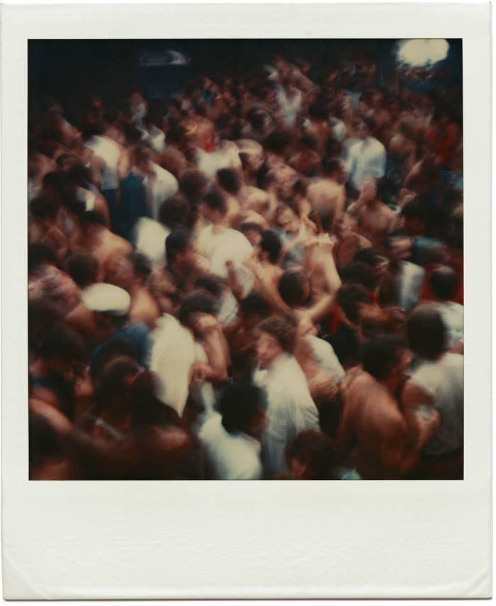 A polaroid provided by the artist Tom Bianchi of a Fire Island party packed with people from his collection of work documenting life on the island from 1970 to 1983 