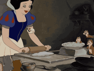 Snow white rolling dough with a rolling pin