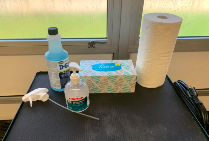 a picture of some tissues, a paper towel roll, and some cleaning fluid