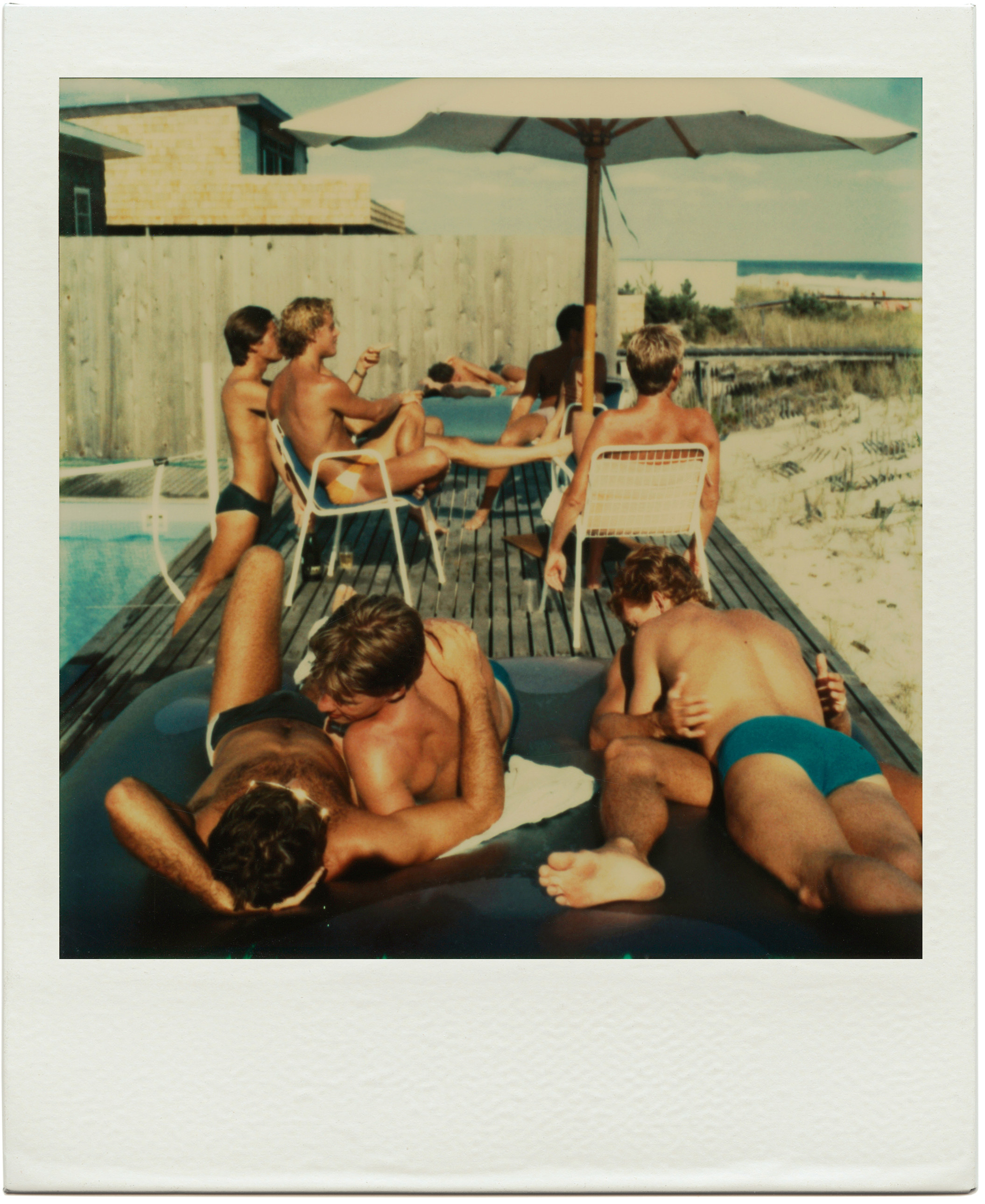 A polaroid provided by the artist Tom Bianchi of a group of men hanging by a pool