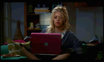 Kaley Cuoco in the TV show &quot;The Big Bang Theory&quot; sitting on the couch, closing her computer, throwing it across the couch, and putting a pillow on top of it