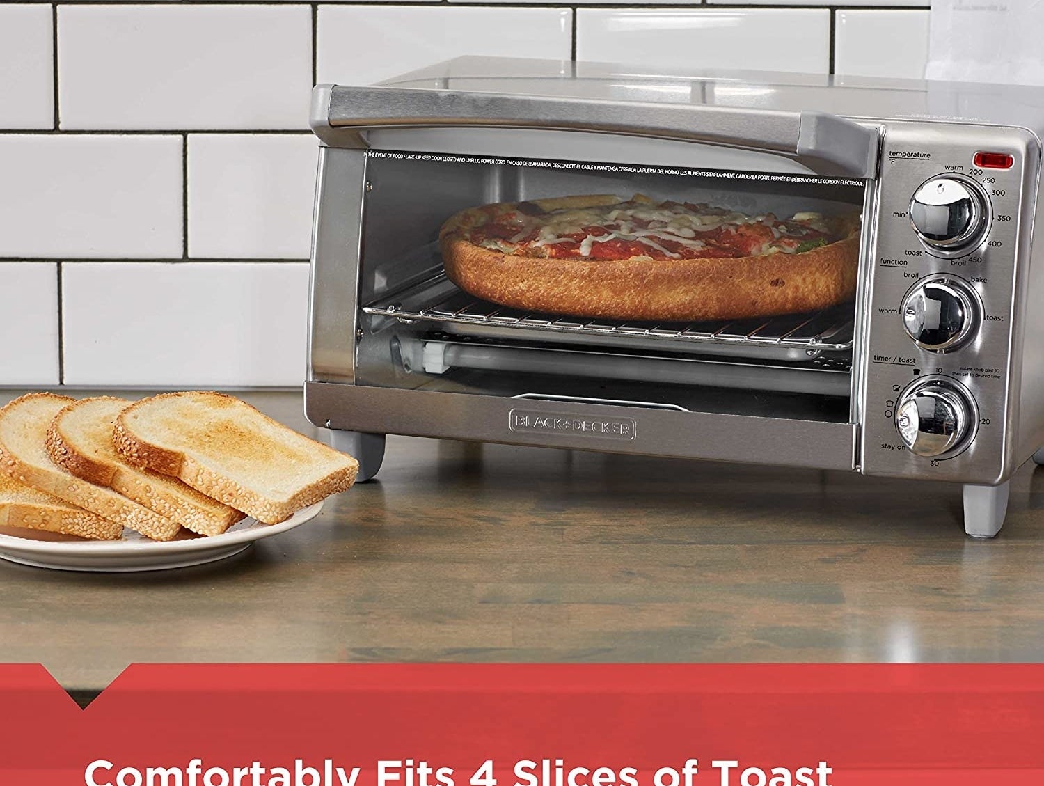A stainless steel toaster oven with three round knobs and a glass door with a pizza inside