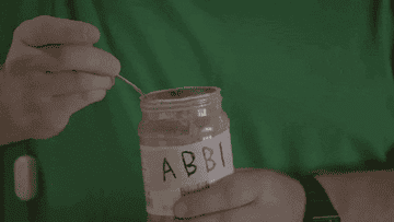 gif of bevers from the tv show broad city eating out of a jar labeled &quot;abbi&quot;