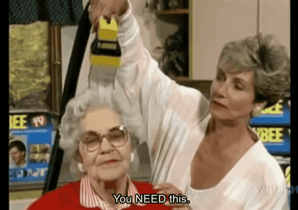 Gif of a woman using a vacuum-like tool on another woman&#x27;s head saying &quot;you need this&quot;