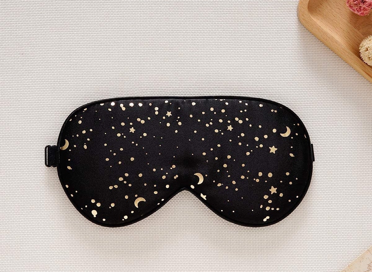 A sleep mask with stars dors and crescent moons