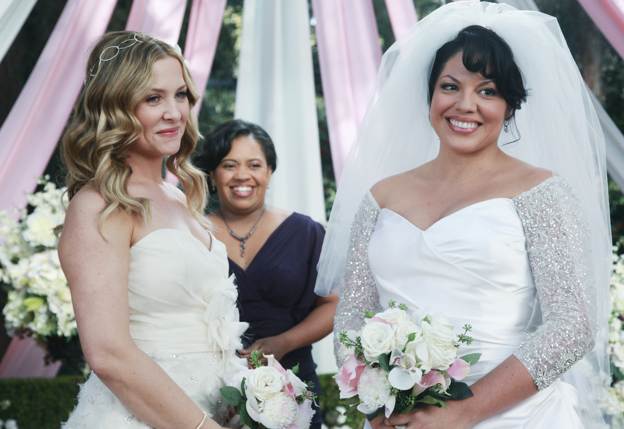Callie and Arizona smiling in their wedding dresses