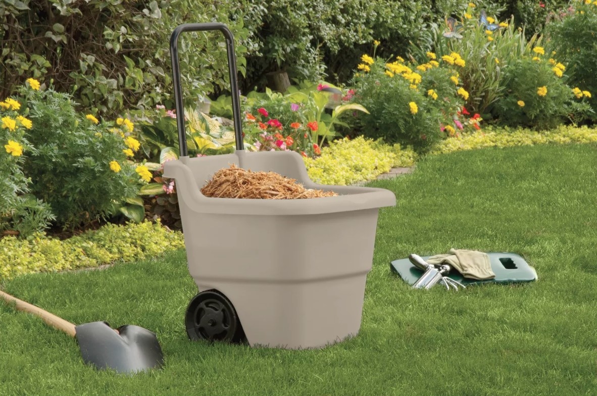 A resin lawn cart with two black wheels