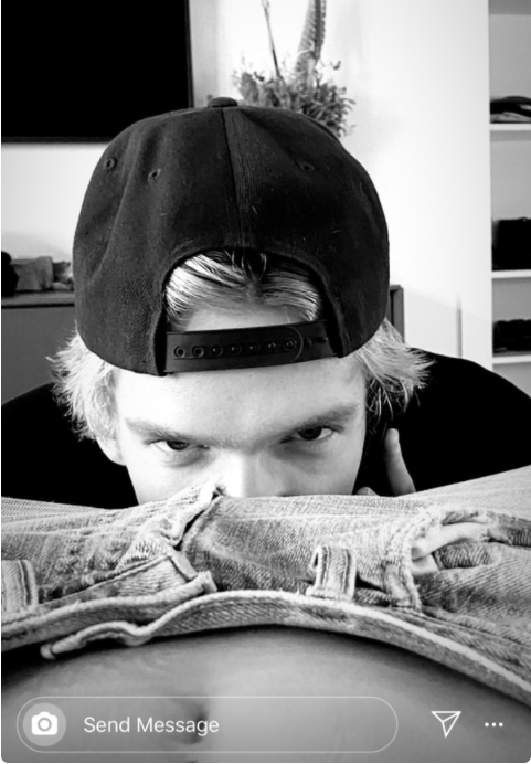 Cody with his head in Miley&#x27;s crotch looking at a camera 