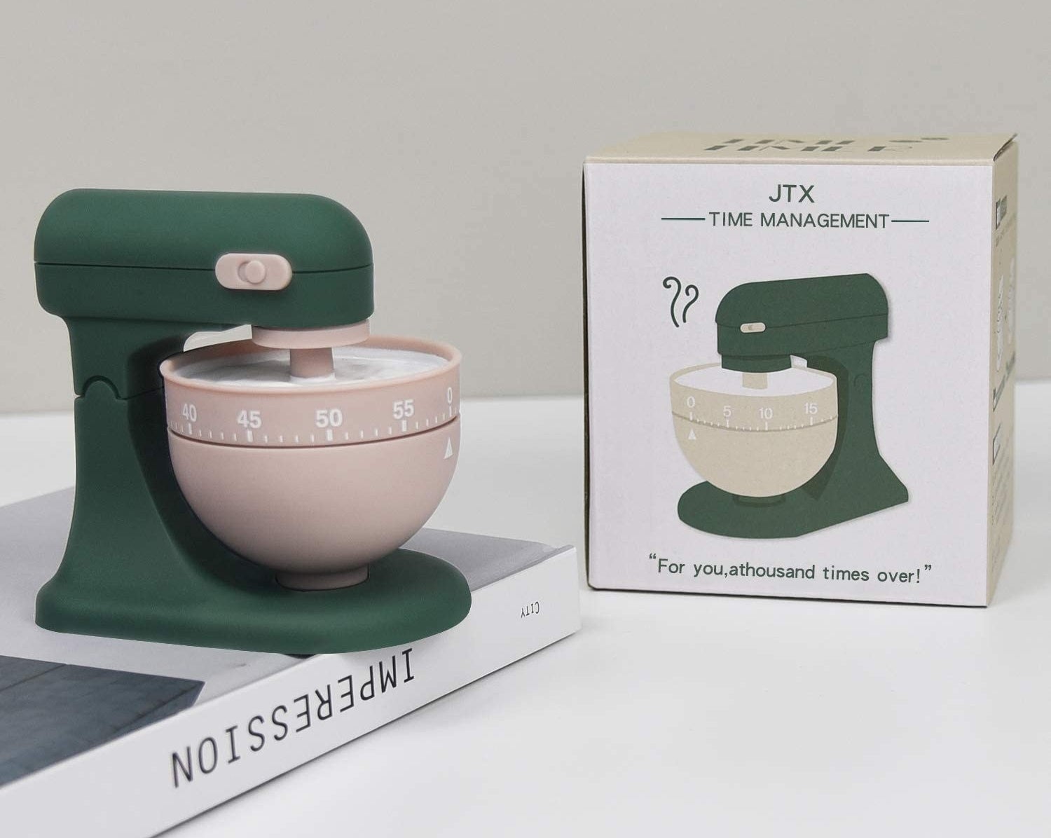 A kitchen time on top of a book next to its packaging