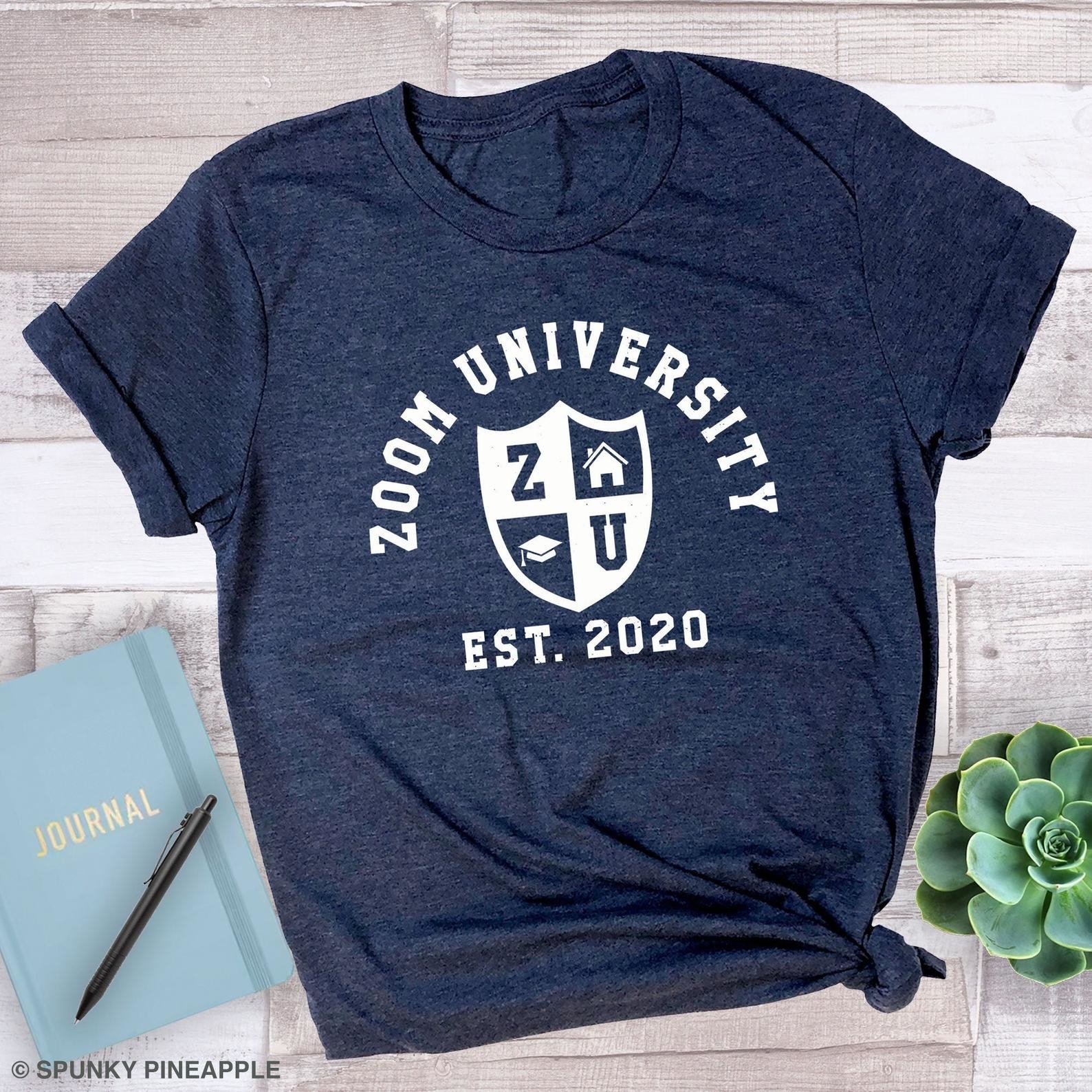 Blue t-shirt with the phrase &quot;Zoom University Est. 2020&quot; and a logo in white on it