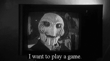 Billy the puppet speaks on a TV screen, text reads: &quot;I want to play a game&quot;