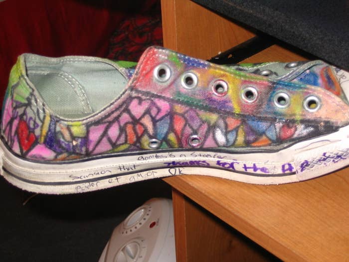 A pair of Converse low tops filled with colorful doodles and handwritten messages