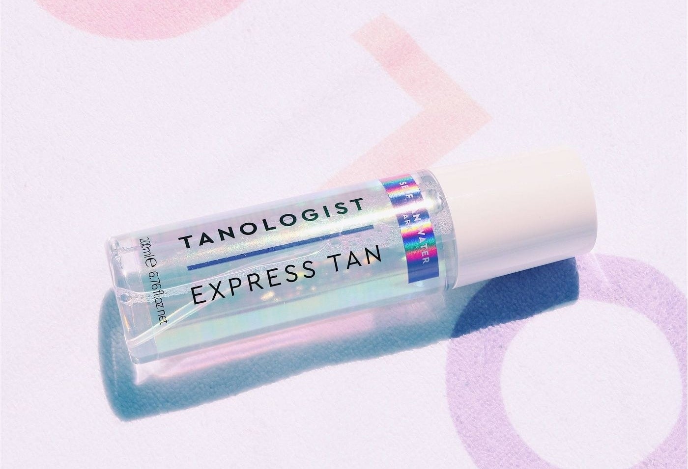 The bottle of clear express tan with a holographic label