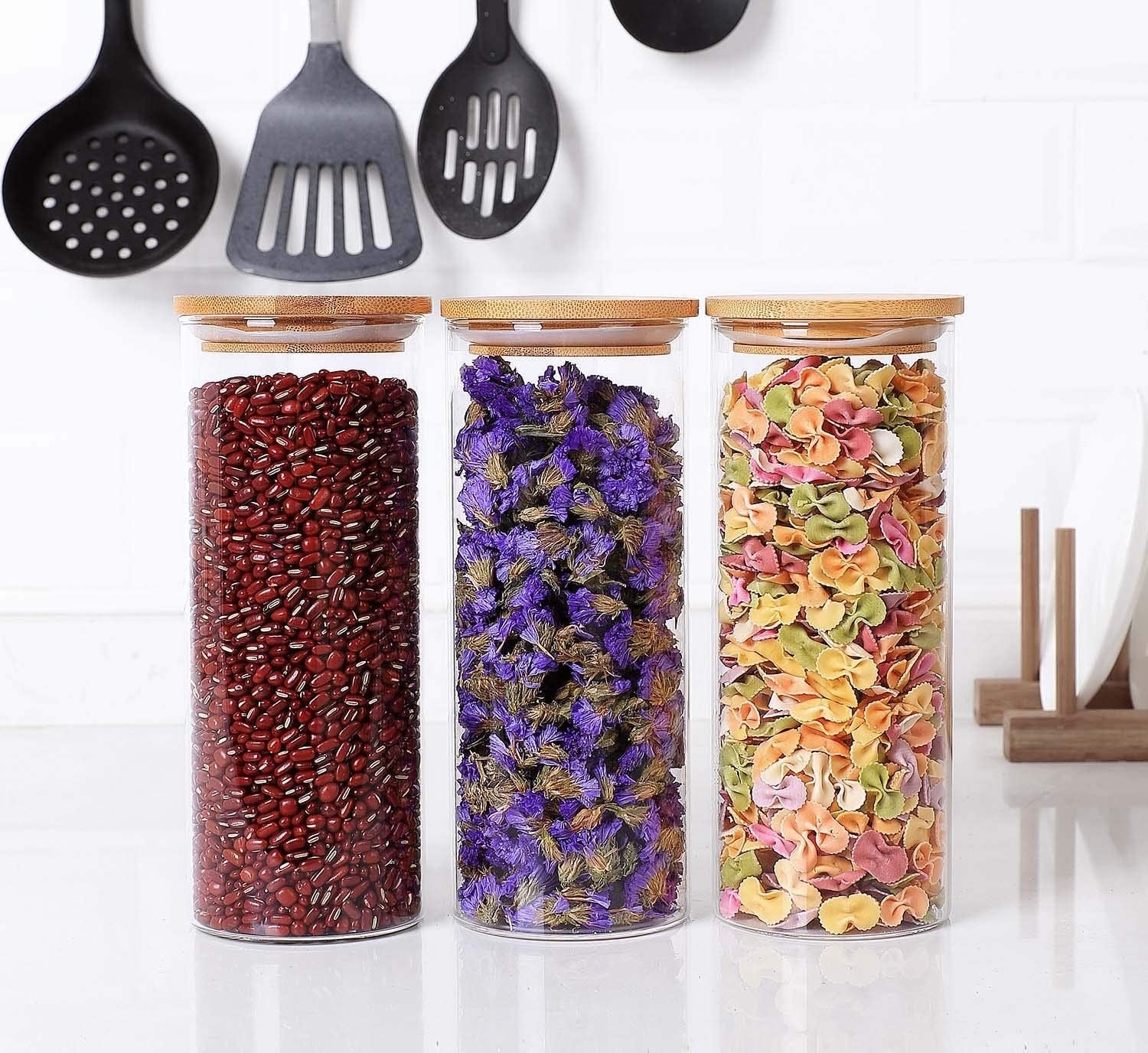 A trio of the glass containers filled with dried goods